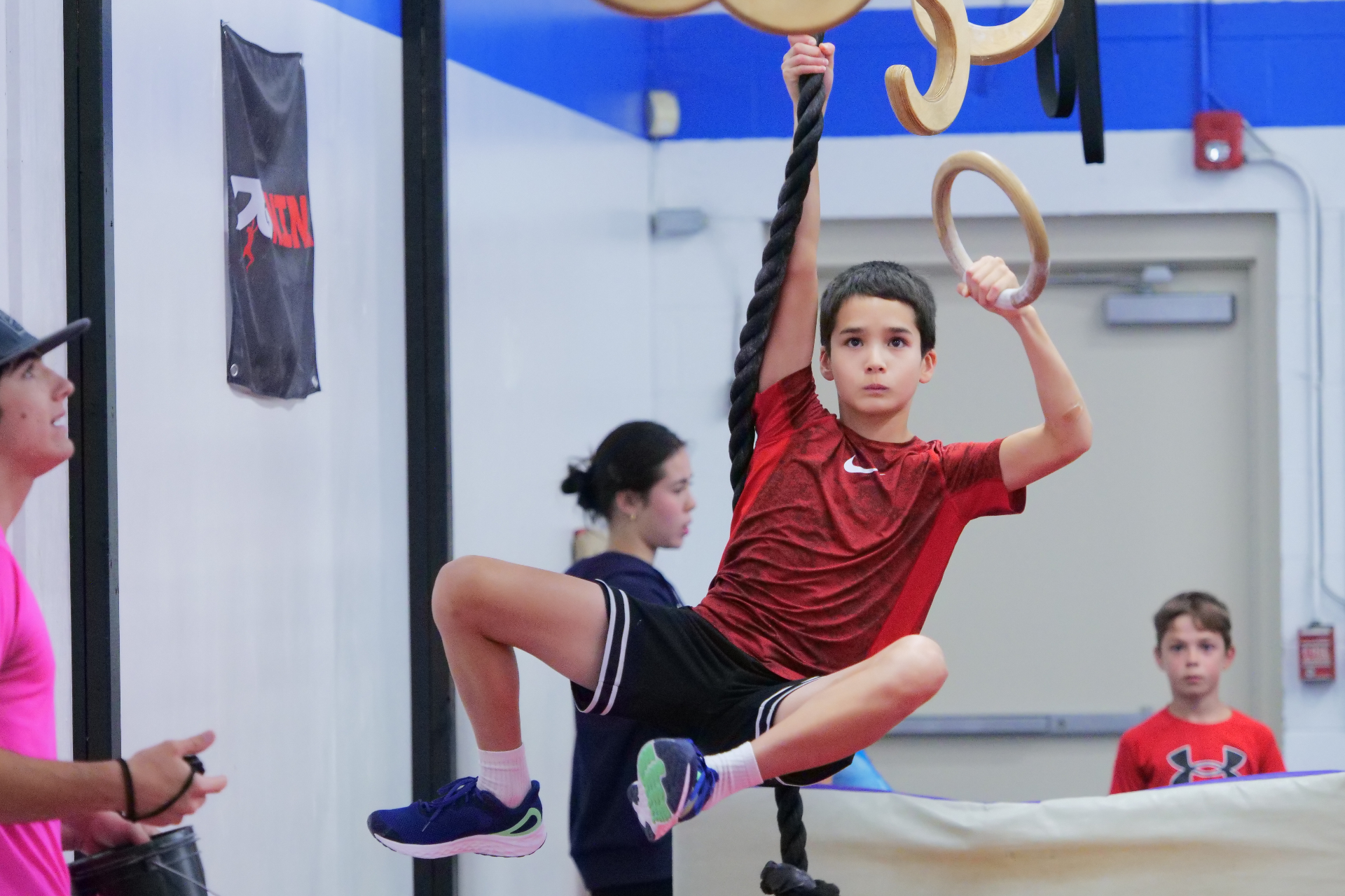 Child training on rings at USA Ninja Challenge